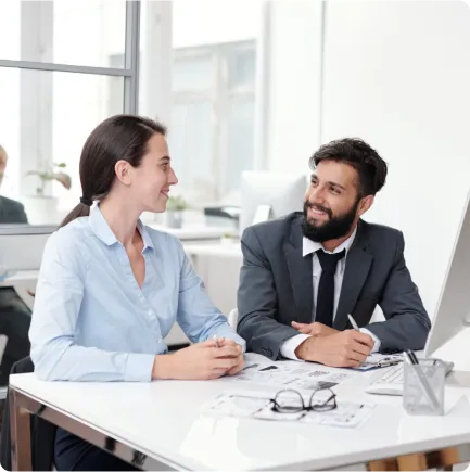 Two professionals discussing at a desk