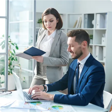 Business professionals collaborating on a laptop